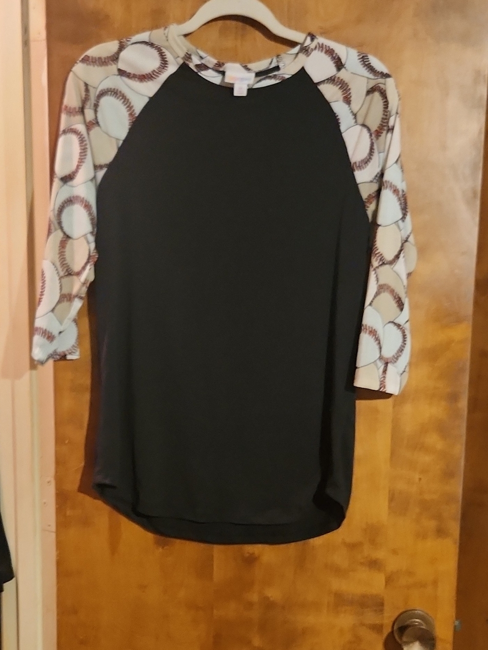 LuLaRoe Black Raglan Top with White & Brown Baseball Sleeve Print